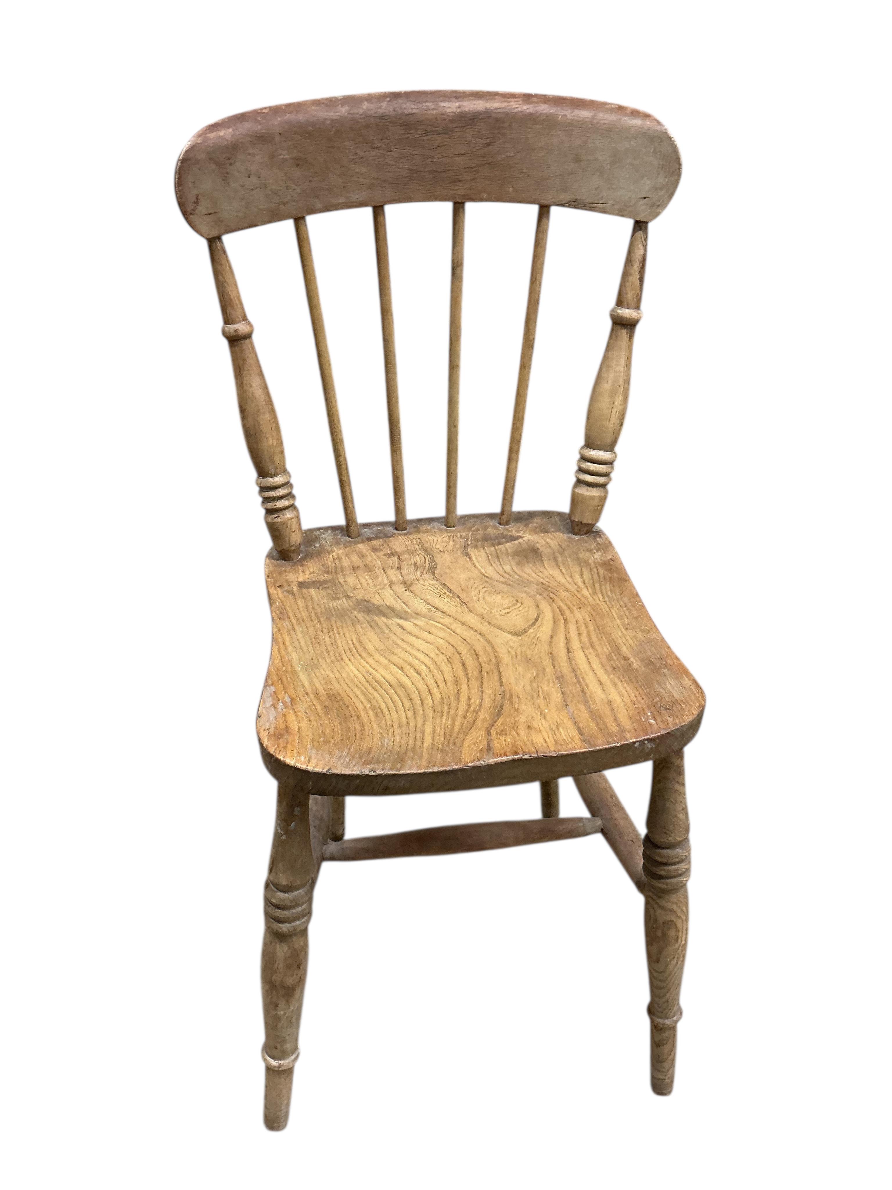 A Victorian rectangular pine kitchen table, width 133cm, depth 82cm, height 72cm together with four Victorian Windsor elm and beech comb back kitchen chairs